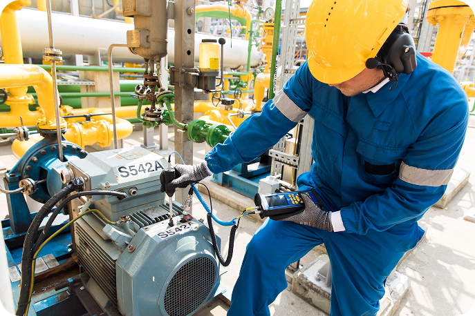 Bearing Condition Monitoring with Ultrasound Technician using an SDT340 ultrasonic detector to measure bearing condition on an industrial motor pump.