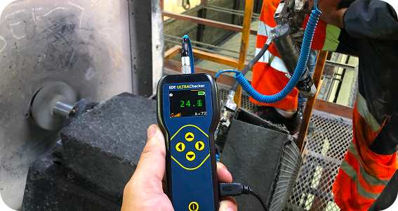 Operator-Driven Reliability with ULTRAChecker Maintenance operator performing condition monitoring using ULTRAChecker handheld ultrasound device.