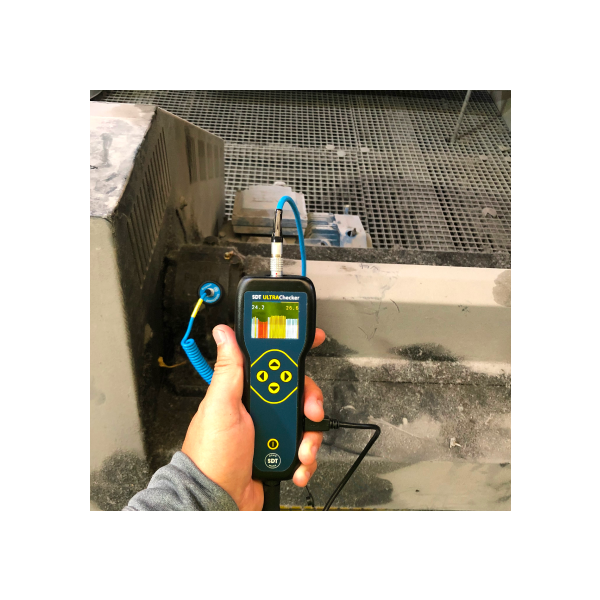 ULTRAChecker in Field Operation Technician using ULTRAChecker to inspect industrial equipment surface for ultrasound readings.